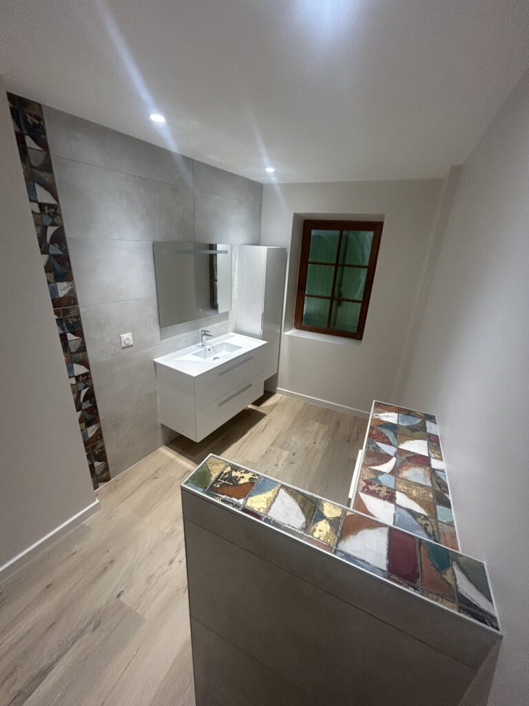 Meuble vasque suspendu installé lors d'une rénovation de salle de bain moderne