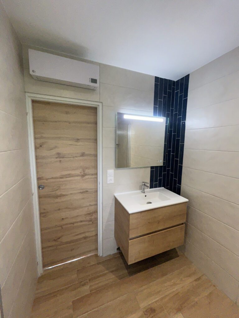 Salle de bain moderne rénovée avec meuble vasque suspendu et douche à l'italienne